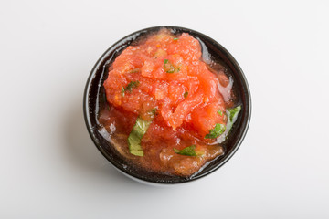 Close up of tomato sauce in a black cup