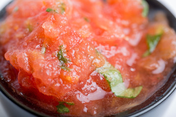 Close up of tomato sauce in a black cup