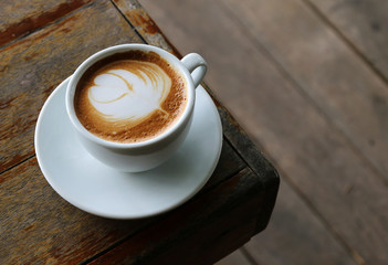 cup of hot coffee on the wood table in coffee shop cafe