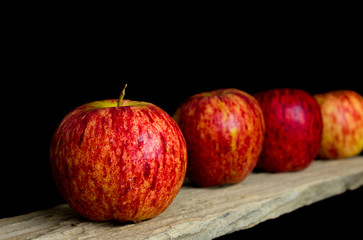 Red apples put on wooden with black background