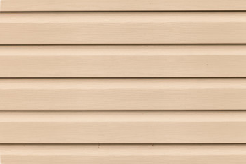 Close up Light brown (beige) vinyl wooden siding panel background with imitation wood texture.