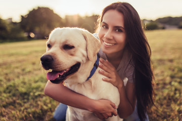 Young woman with dog - obrazy, fototapety, plakaty