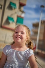 Very happy young girl playing outdoors.