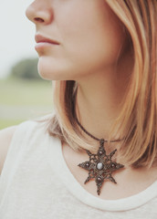 Portrait of beautiful woman with necklace on her neck