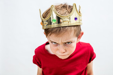 rebellious spoiled kid with crown for mad attitude, high angle