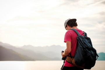 Fototapeta premium man traveling walking with backpack at national park in the jungle day time sun shine on holiday at weekend relax fresh on background nature view