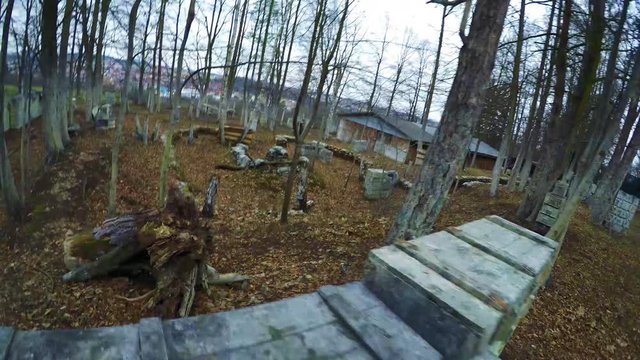 POV GoPro - a paintball player sneaks across the field and scans the area