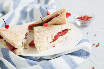 Club sandwich with meat, cucumber and cream cheese