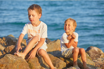 boy on the stony shore of the black sea