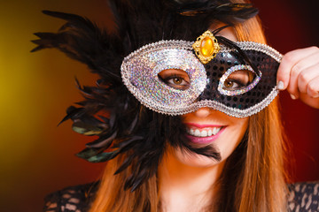 Woman holds carnival mask closeup