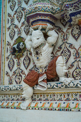 Obraz premium Traditional Thai style sculptures and painting of monster,animals and gods in church under decoration of Wat Pariwat