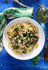 Tagiatelle pasta with spinach and ham - obrazy, fototapety, plakaty