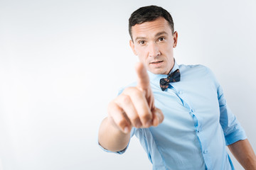 Serious confident man looking at you