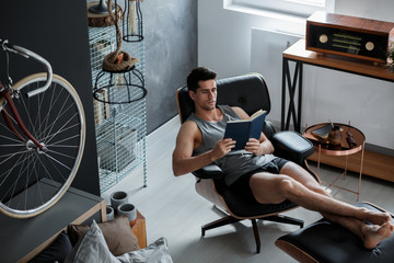 Handsome man reads book