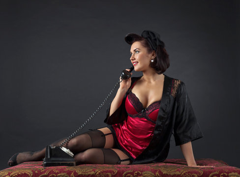 Beautiful woman speaking via vintage phone.