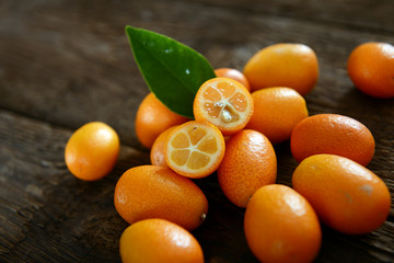 Kumquat fruits on old wooden table