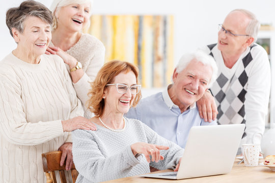 Elderly people looking at laptop