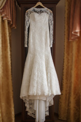wedding dress   hanging  in room