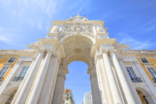 Prospective view of Rua Augusta Triumphal Arch in Commerce Square or Praca do Comercio. Rua Augusta Arch is a stone historic building and visitor attraction in Lisbon, Baixa District, Portugal.
