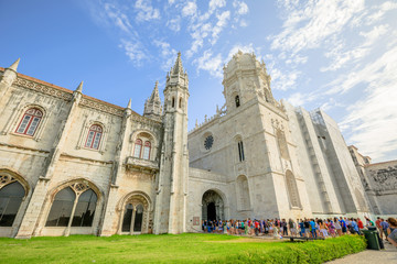 Fototapeta na wymiar Crowd of people at entrance of Hieronymites Monastery or Mosteiro dos Jeronimos, Lisbon, Belem district on blurred background. The monastery is one of the city's main attractions and popular landmark