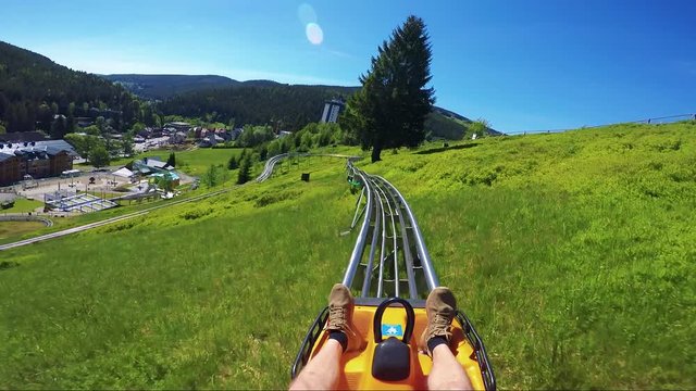 POV GoPro - a man rides a small roller coaster in a rural area