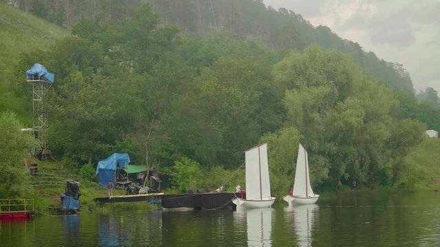 Preparations of scene on water of river for evening concert.