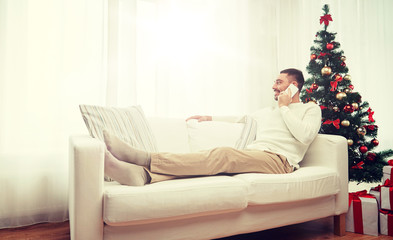 man calling on smartphone at home for christmas