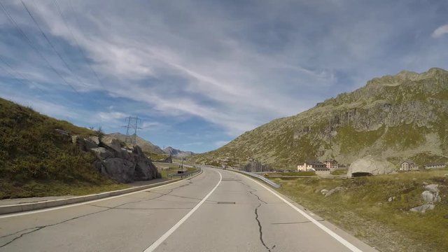 San Gottardo, Switzerland. Driving shot, vehicle point-of-view. Camera on car roof. Driving around the mountain pass