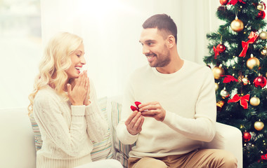 man giving woman engagement ring for christmas