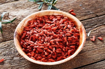 Dried goji berries on wooden background