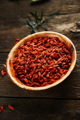 Dried goji berries on wooden background