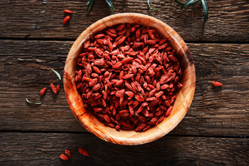 Dried goji berries on wooden background