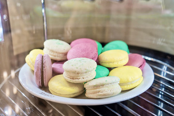 Macaron or Macaroon French cookies on the white plate - great desert for cup of coffee