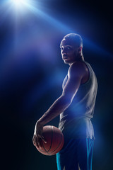 Fototapeta premium The portrait of a basketball player with ball