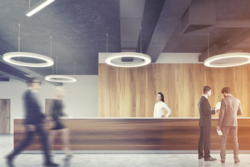 Wood reception in round lamp office, people