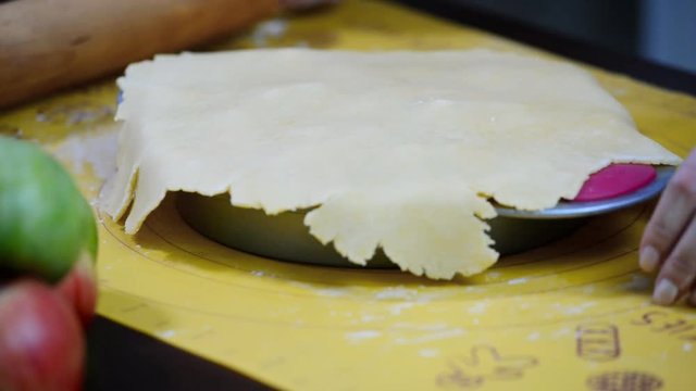 Girl in the kitchen preparing an Apple pie