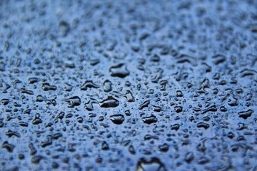 Close up of water drops on the dark surface