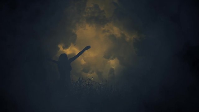 A mysterious Girl Lifting her Arms to Strange Lightning Storm