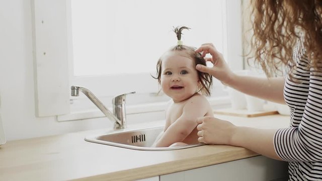Cute little girl washes her hair clean kid after shower children hygiene child taking bath