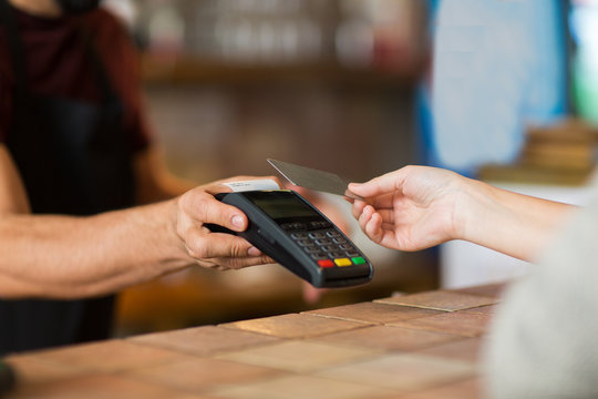 Hands With Payment Terminal And Credit Card