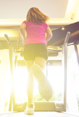 strong woman exerciseing in fitness gym for healthy with sunlight.