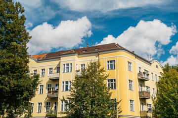 yellow house at prenzlauer berg with fluffy clouds