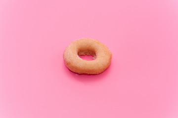 Fried Donuts with sugar topping on pink background