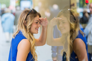 young woman at a shop window