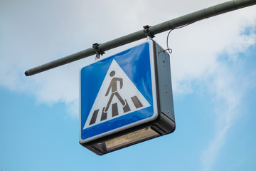 blue pedestrians sign on traffic light