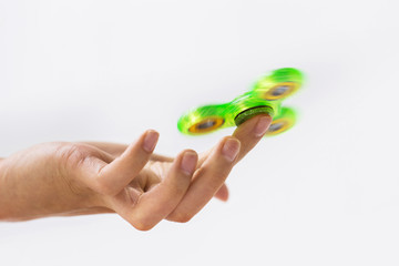 close up of hand playing with fidget spinner