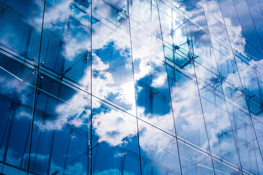 darken colored glass facade with cloud reflections