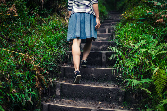 Woman walking up steps in the forest