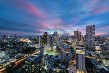 Fototapeta na wymiar Bangkok skyline on colorful sunset sky and street lights
