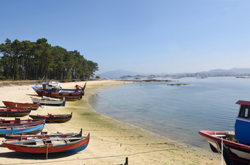 Fototapeta na wymiar Arousa Island boats on the beach Praia Cabodeiro, Pontevedra province, Galicia, Spain